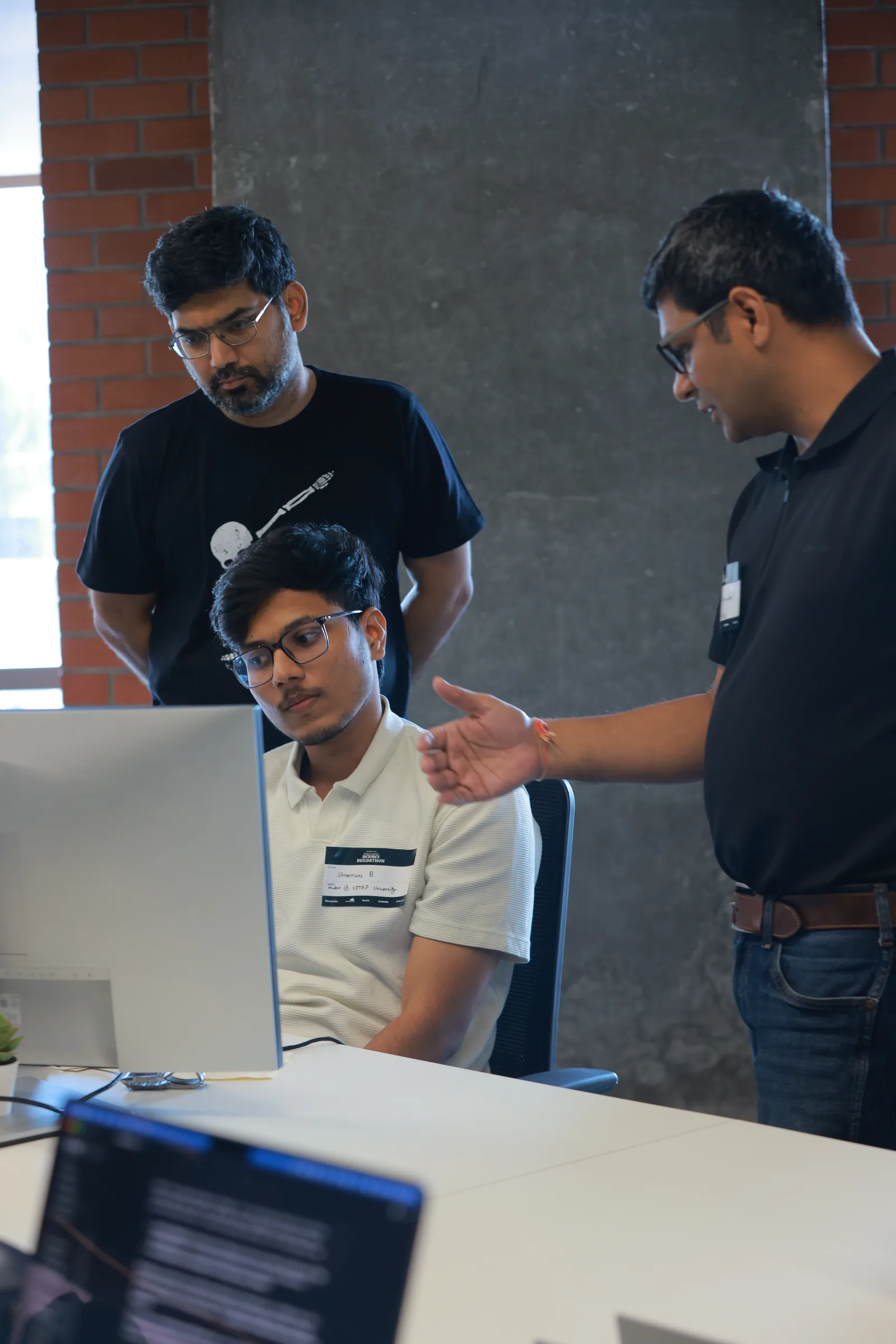 Mentor reviewing the build — Hermes Buildathon badge visible